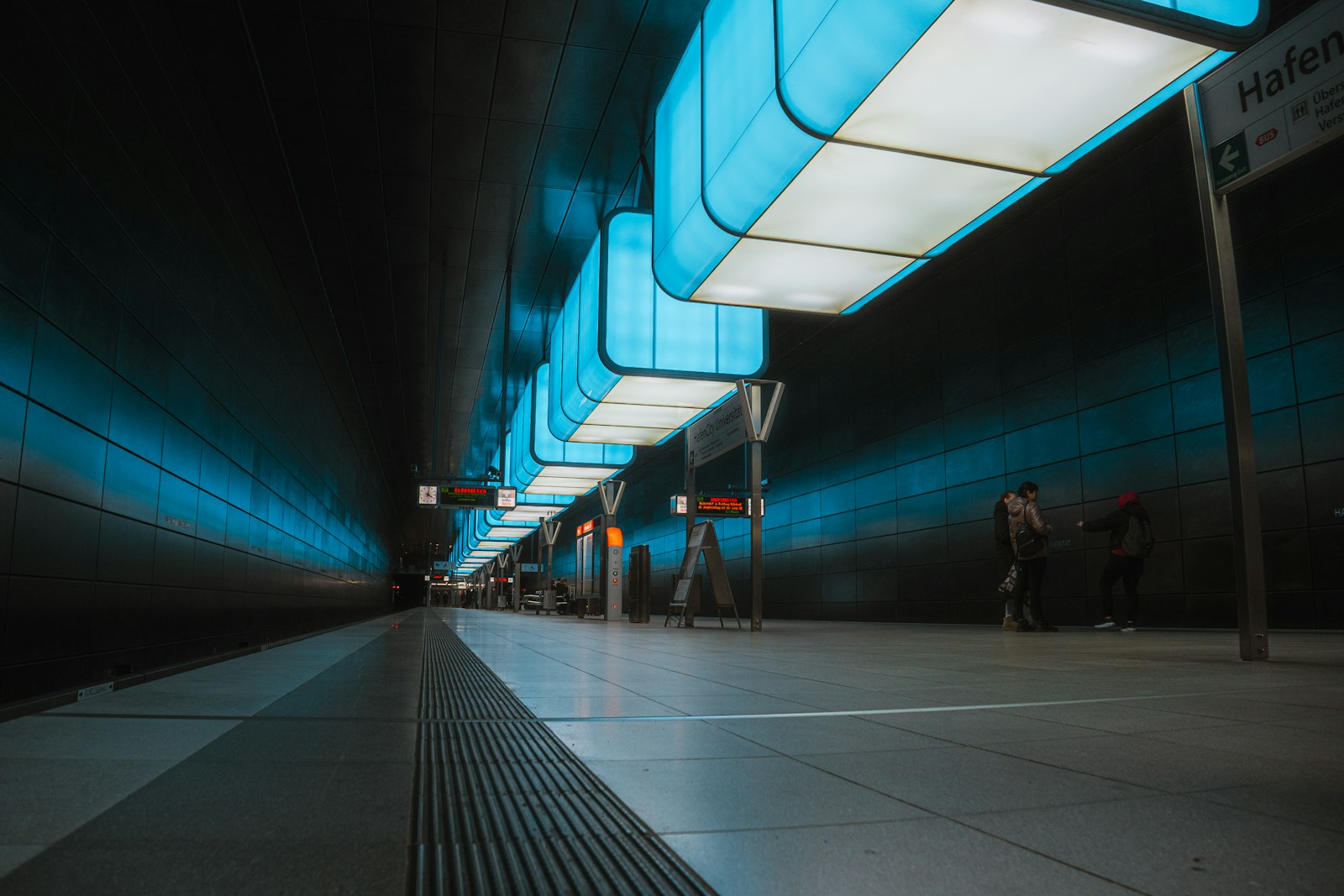 A subway station with people waiting for the train