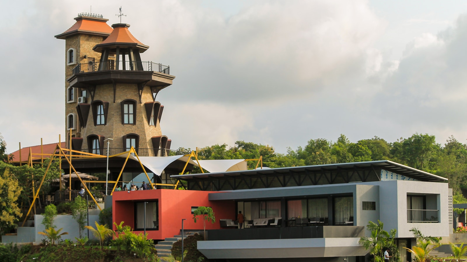 A house on a hill with a tower in the background